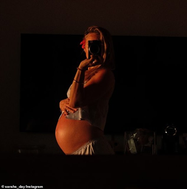 Sarah (pictured) shared a photo of her growing baby bump on Instagram on Thursday