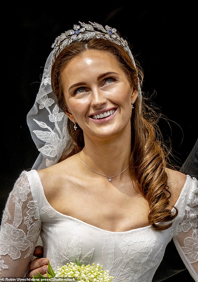 Sophie-Alexandra, a PhD candidate in criminology, looked stunning in a classic white dress, featuring floral detailing on the princess skirt and sheer long sleeves