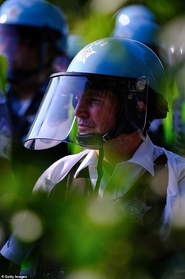 Chicago police look on as protesters gather during the Democratic National Convention on August 19, 2024 in Chicago, Illinois. Multiple protests are planned during the DNC, which runs August 19-22 at the United Center.