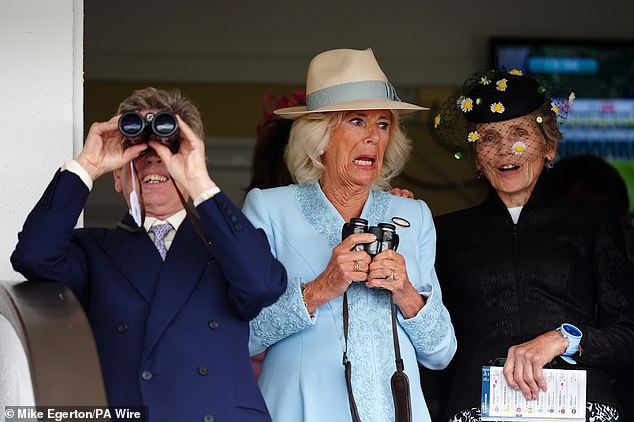 The royal gave a lively show in the Royal Box and was joined by race manager John Warren (left)