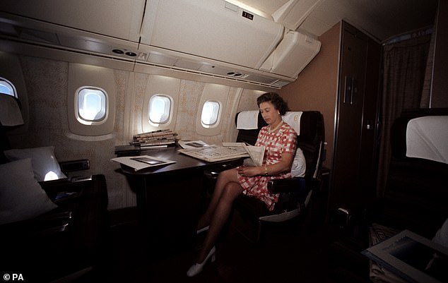 The Queen reads newspapers on her flight home from Bridgetown, Barbados, in the supersonic Concorde after her Silver Jubilee tour of Canada and the West Indies