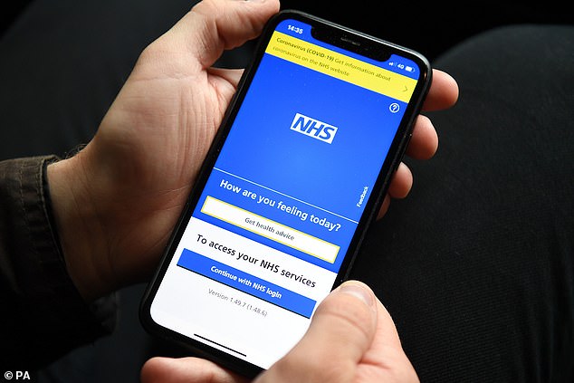 Person holding a mobile phone with the NHS app. The Mail on Sunday has revealed that the NHS app is used to book less than 1% of GP appointments, prompting users to question its usefulness