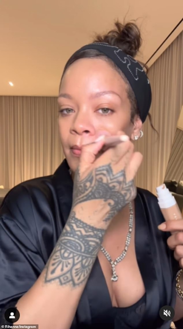 Rihanna wore an expensive diamond necklace and an open, black silk dress to film a tutorial on how to apply her brand new $40 Fenty Beauty medium-coverage foundation, which is supposed to be 