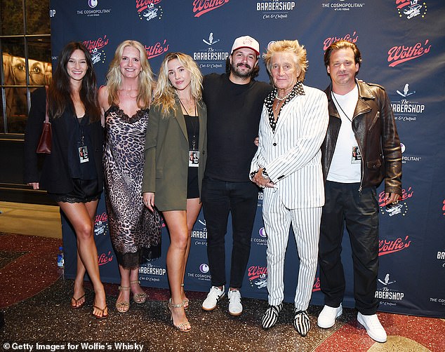 Sir Rod Stewart and Penny Lancaster huddled together in Las Vegas on Saturday with their blended family (left to right: Renee Stewart, Penny, Nicole Artukovich, Liam Stewart, Rod and Sean Stewart)