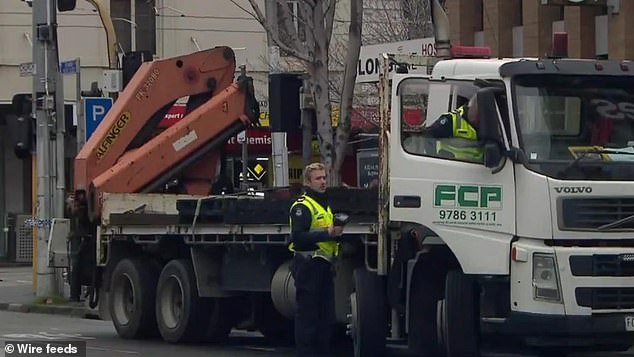 The driver of the truck (pictured) that struck and killed AFL journalist Sam Landsberger in Melbourne on Tuesday has been charged by Victoria Police