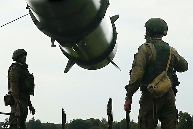 A terrifying secret hit list of locations in the UK that the Russian navy would attack with nuclear missiles in the event of a war with NATO has emerged. Pictured: Russian soldiers load an Iskander-M short-range ballistic missile launcher as part of a Russian military exercise designed to train troops in the use of tactical nuclear weapons.