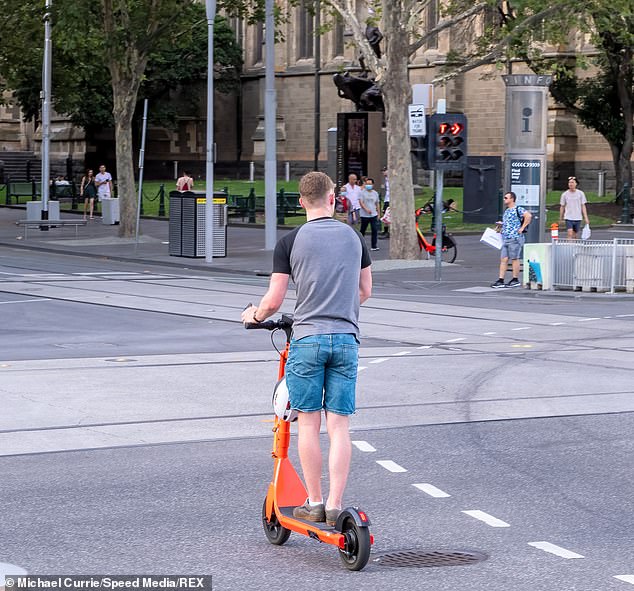 Following a surge in complaints from residents and businesses, Melbourne's Mayor is set to introduce a motion to cancel e-scooter operators' contracts (pictured is an e-scooter rider in Melbourne)