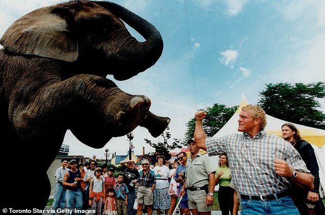 Sid Eudy - also known as 'Sycho Sid' - poses with an elephant in Toronto in 1996