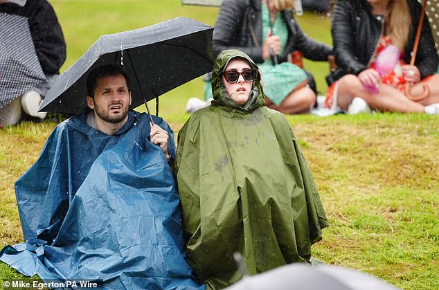 Britons were forced to swap their T-shirts and sunglasses for jumpers and jackets last month as the UK experienced its coldest start to July in 20 years. Pictured: Spectators at Wimbleon on July 9