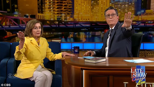 Stephen Colbert is seen pointing at anti-Israel protesters who interrupted his interview with Nancy Pelosi