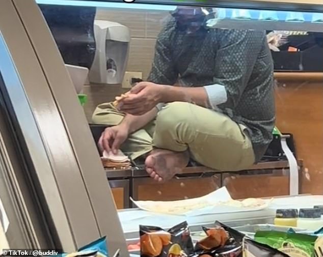 Customers waited to order at a Subway in Chicago as a man in brown pants and a green shirt sat at the counter with dirt at his feet