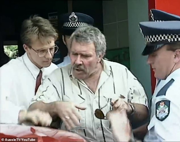 Jack Karlson wrestles with police outside a Brisbane restaurant on October 11, 1991, in one of the most-watched arrest videos of all time. His arrest for suspected credit card fraud was a mistake - but his real life story is far more extraordinary