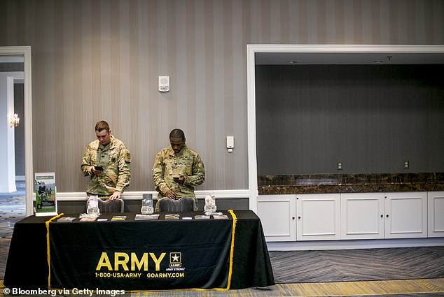 Army leaders have spoken of challenges in recruiting, leading to a shortage of as many as 15,000 soldiers last year. Pictured: Army recruiters at a career fair in Michigan