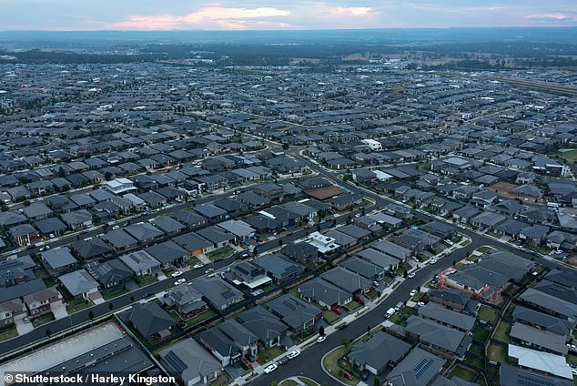 An Australian who wants to buy a typical house in a big city now has to earn more than $200,000 a year. Pictured are houses in Sydney's south-west