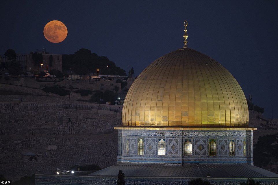 JERUSALEM: The supermoon rises behind the Dome of the Rock shrine on the grounds of the Al Aqsa Mosque in Jerusalem's Old City