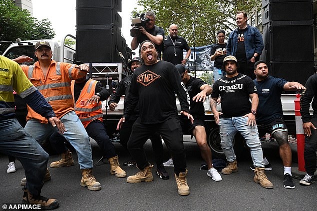 Thousands of tradesmen put down their tools and walk off construction sites to demonstrate in solidarity with the beleaguered CFMEU (pictured: CFMEU union members in April 2023)