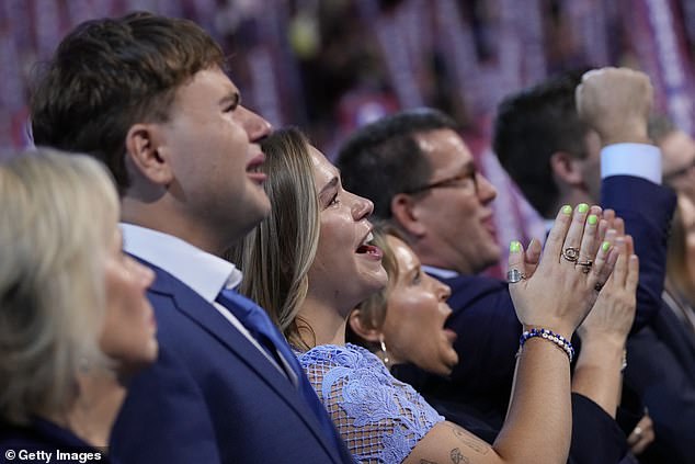 Gwen, Gus and Hope Walz watch their father Tim take the stage