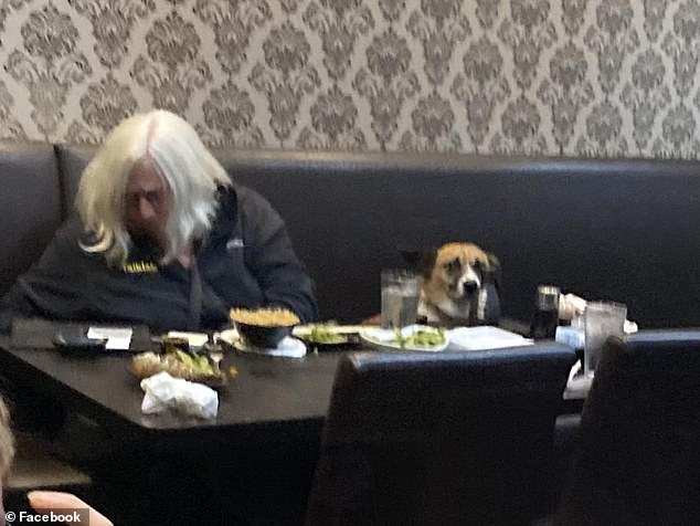 The photo, taken at the Sapporo Japanese Steakhouse in Rock Springs, Wyoming, shows an elderly woman sitting at a table with her small dog