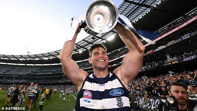 Hawkins won three flags in his glittering career with the Cats - including their 2022 triumph over the Swans (pictured)