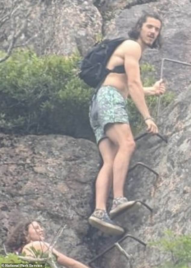 A man and woman are pictured climbing a section of the Precipice Trail, which is closed at this time of year to protect nesting peregrine falcons.