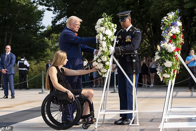 Former U.S. Marine Corps Cpl. Kelsee Lainhart and Donald Trump lay a wreath at the Tomb of the Unknown Soldier at Arlington National Cemetery