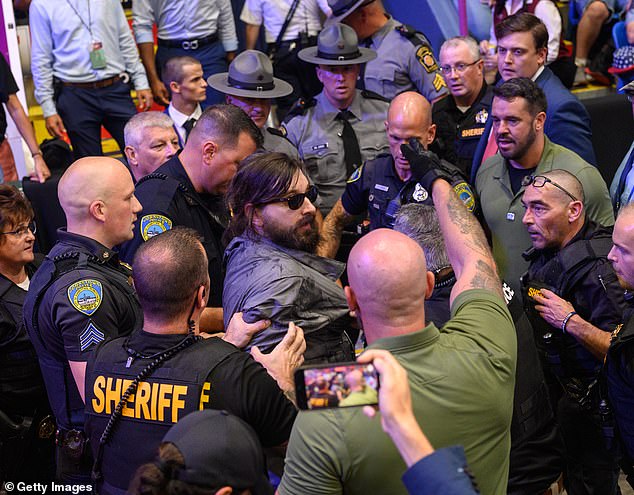 A man (center) at GOP candidate Donald Trump's rally in Pennsylvania had to be tasered to the ground after he tried to jump into the press room