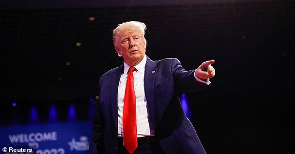 ARCHIVE PHOTO: Former U.S. President Donald Trump points to his supporters as he leaves the stage after a speech during the Conservative Political Action Conference (CPAC) in Orlando, Florida, U.S., February 26, 2022. REUTERS/Marco Bello/File photo