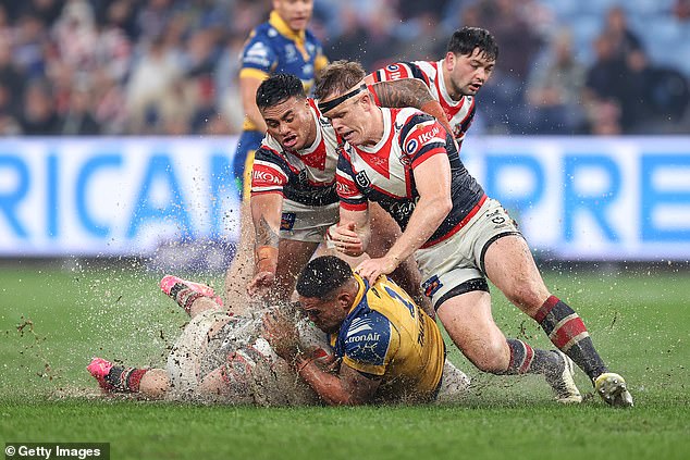 Sydney Roosters and Parramatta Eels players had to deal with large puddles of water on the pitch at the new Allianz Stadium