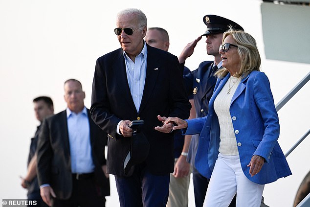 President Joe Biden helps first lady Jill Biden disembark from Air Force One at Dover Air Force Base prior to departure for Rehoboth Beach