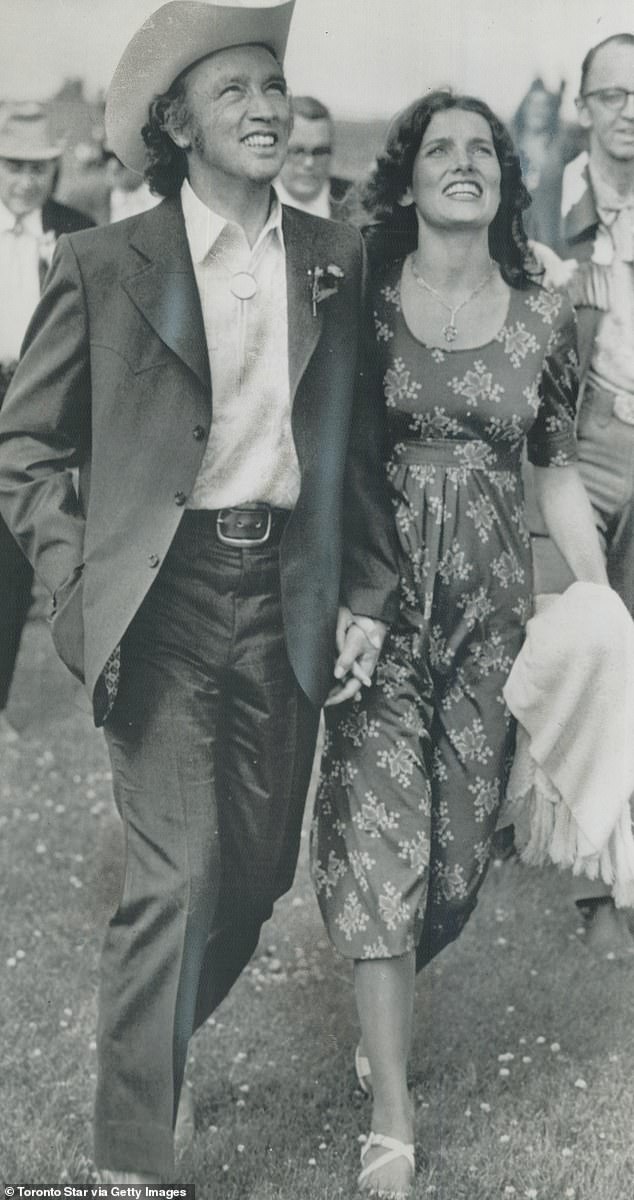 Pierre Trudeau and his wife Margaret walk hand in hand through Heritage Park in Calgary