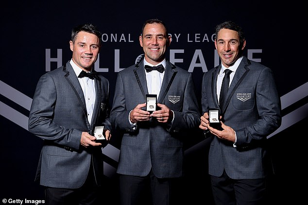 Football legends Cooper Cronk, Cameron Smith (centre) and Billy Slater (right) are pictured in a very rare moment after being inducted into the NRL Hall of Fame