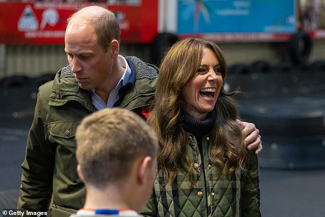 William puts his arm around Kate as they chat with members of the charity during a visit to Scotland last year