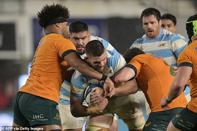 Los Pumas flanker Marcos Kremer is tackled by Australian Wallabies flanker Rob Valetini and hooker Matt Faessler