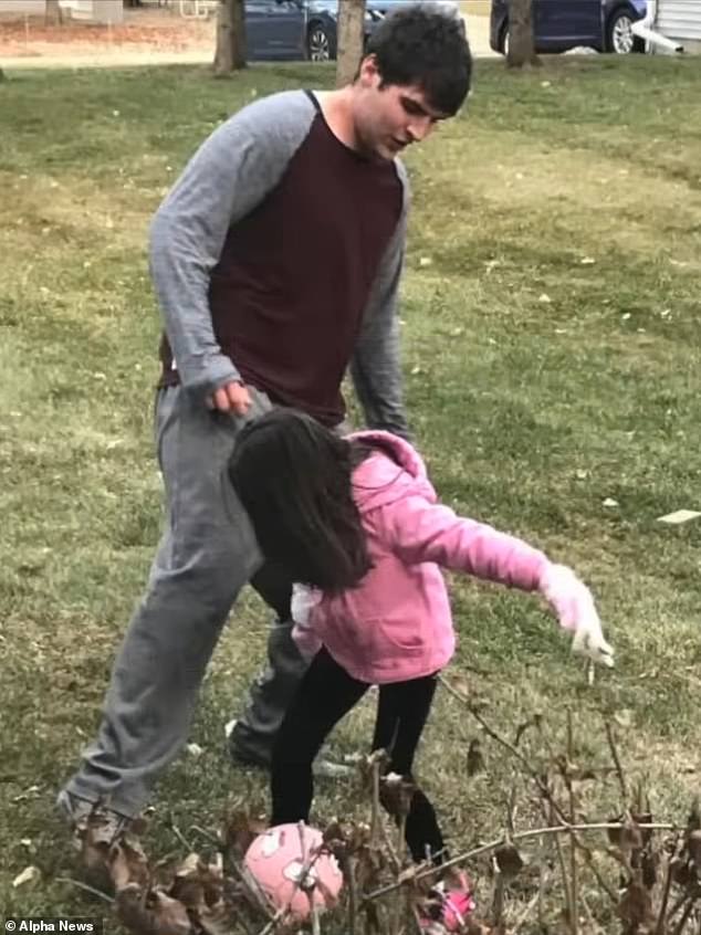 Adams kicks a soccer ball around while playing with his sister