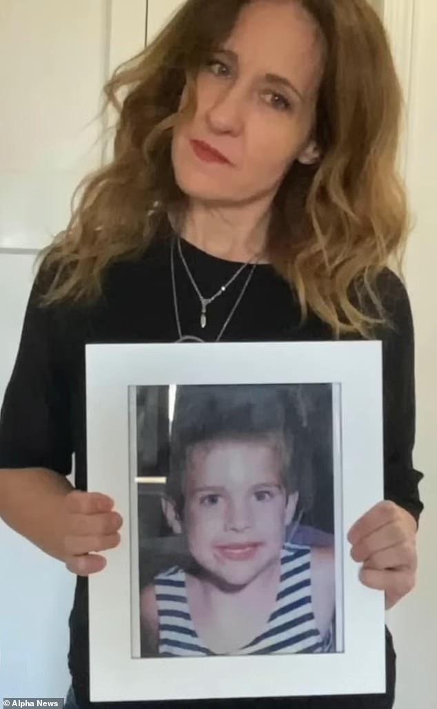 Kim holds a photo of her son as a child as she remembers him