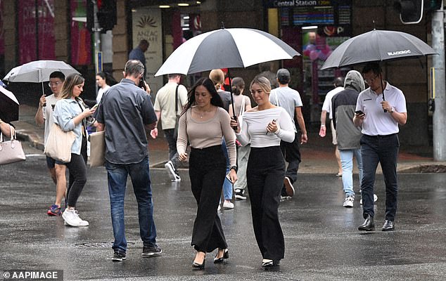 Hobart will see persistent, isolated showers for most of the week, while scattered rainfall is also expected in Melbourne and Adelaide (pictured people with umbrellas on a rainy day)