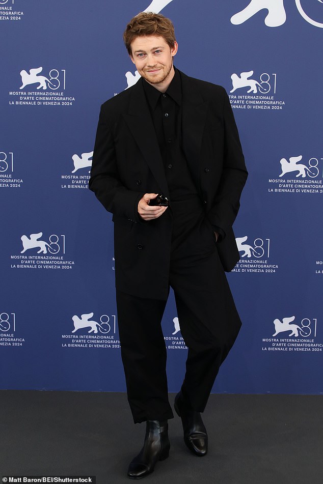 She was joined by fellow actor Joe (pictured), 33, who looked equally stylish in an all-black ensemble, consisting of a black shirt and suit with boots