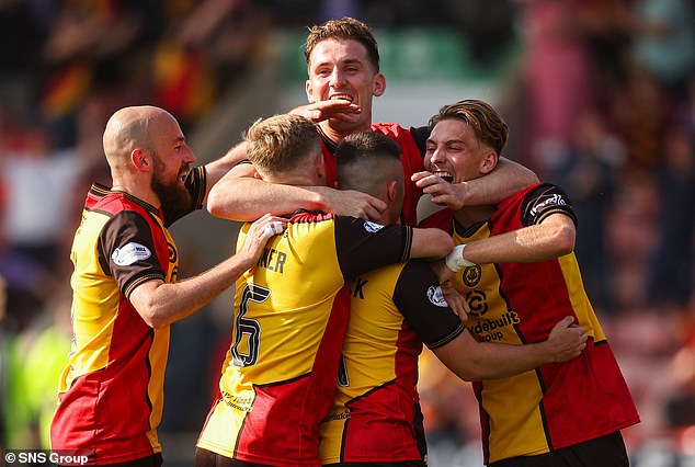 Partick Thistle players celebrate their final goal in a decisive 3-0 victory