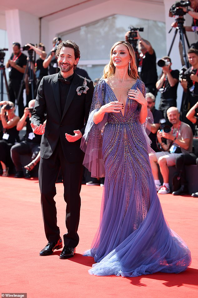 English fashion designer and actress Georgina shone in a deep blue dress with beaded details and sheer sleeves