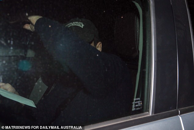 Rory Amon tried in vain to avoid the media at Dee Why police station on Sunday evening