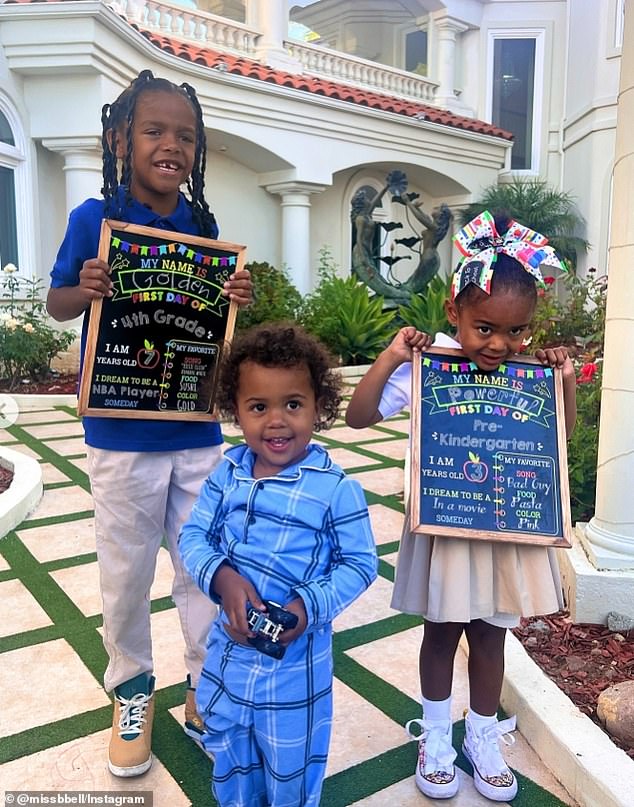 In the adorable photo, Golden and Powerful hold their first day of school signs alongside their younger brother in his pajamas