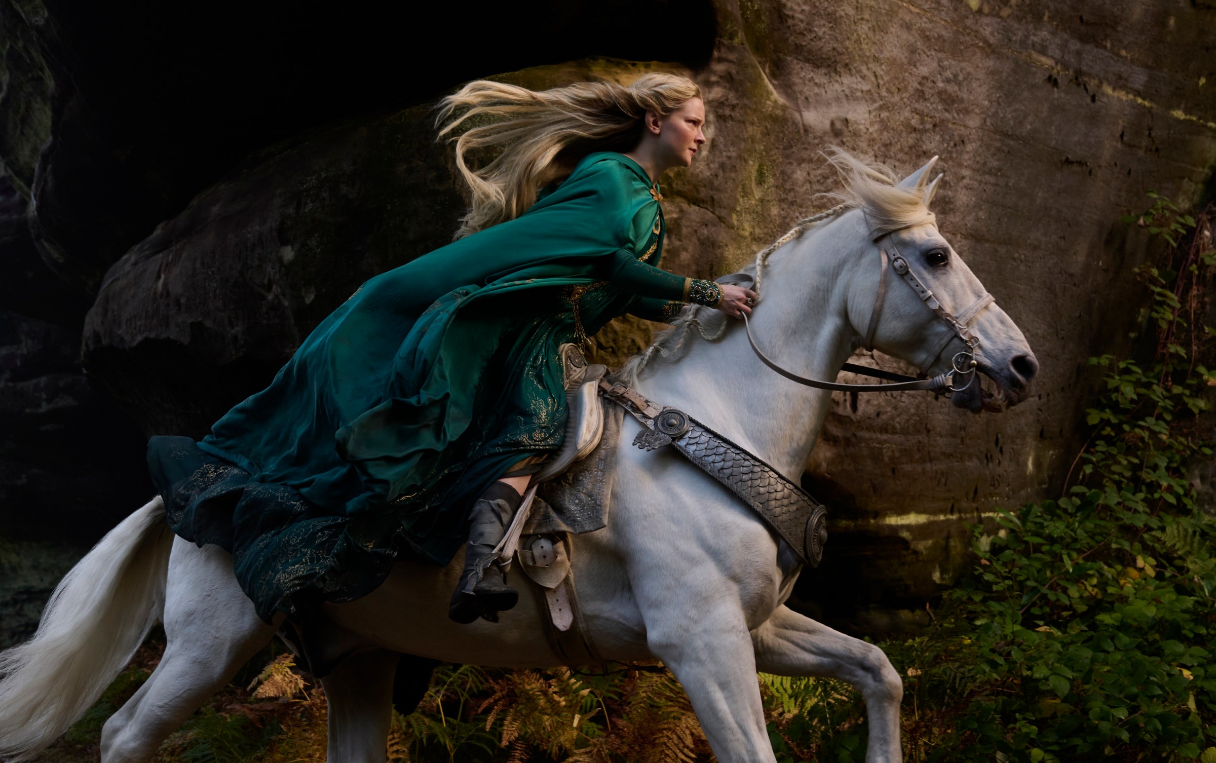 Galadriel rides a white horse in a still from Rings of Power