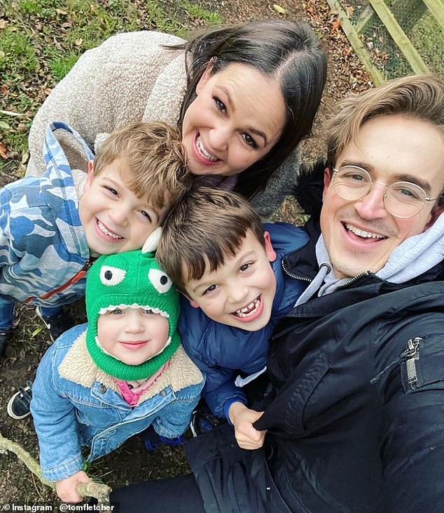 Tom said: 'Since becoming a dad my mental health has been the best it's ever been. Being a children's author is part of that' (pictured: Giovanna, 39, with Buzz, 9, Buddy, 7, and Max, 4