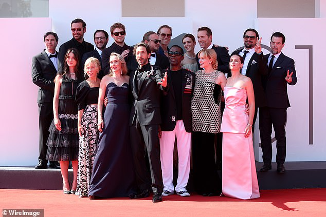 The Brutalist cast (from back left) Joe Alwyn, Brady Corbet, Guy Pearce, Stacy Martin, Alessandro Nivola; (from front right) Raffey Cassidy, Mona Fastvold, Adrien, Isaach de Bankolé, Emma Laird and Felicity Jones