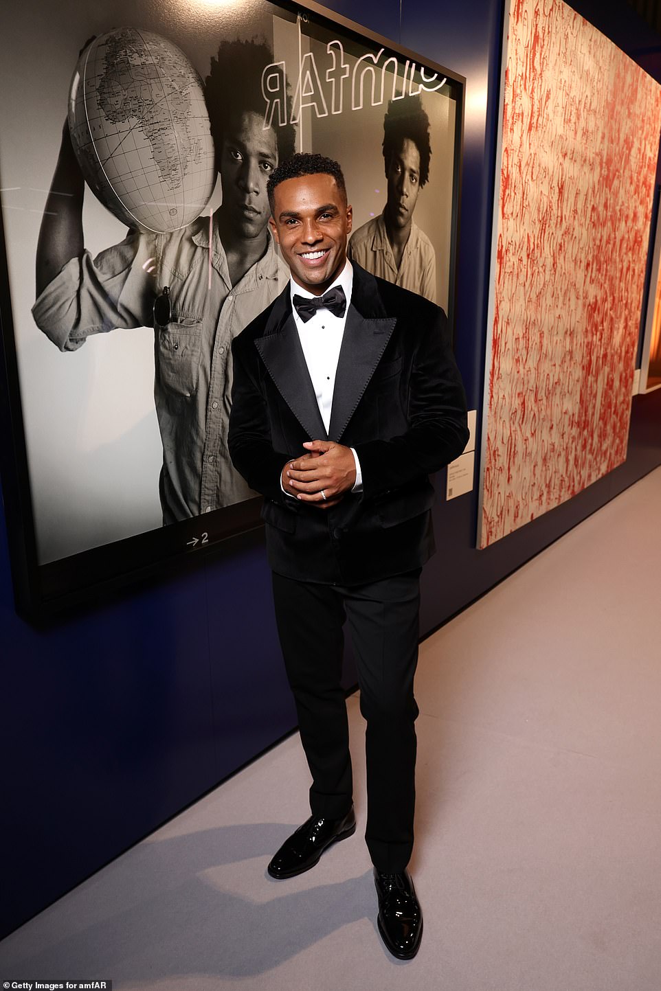 Emily In Paris star Lucien Laviscount looked handsome in a black suit and a crisp white shirt as he posed in the party room