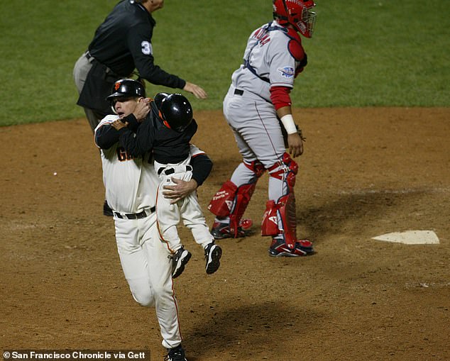 JT Snow grabs Dusty Baker's 3-year-old son Darren during Game 5 of the 2002 WS