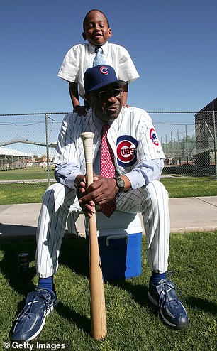 Chicago Cubs manager Dusty Baker and his son Darren wait for a television interview