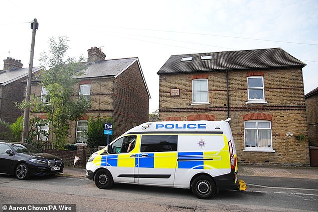 Several mourners left tributes outside the house, with flowers leaning against the wall of the property in Staines-Upon-Thames today