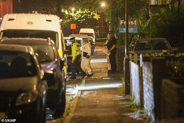 Forensic teams were photographed outside the site where the bodies were discovered