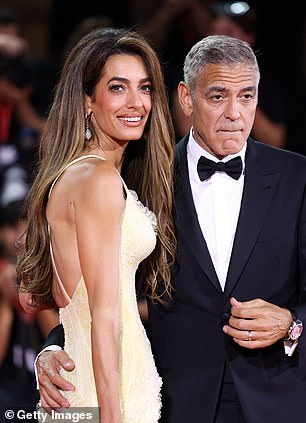 George Clooney is pictured on the red carpet in Venice with his wife Amal